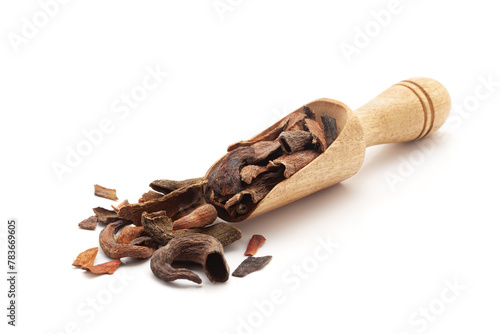 Front view of a wooden scoop filled with Organic Zebrawood or Kakda Singi (Pistacia integerrima). Isolated on a white background. photo
