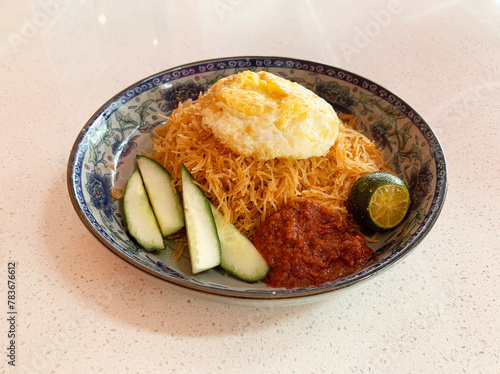 Obraz na płótnie traditional peranakan wok stir fried nonya mee siam noodle spicy chilli shrimp goreng with egg lime sambal cucumber in plate on vintage table asian cafe hotel luxury halal food restaurant banquet menu w salonie