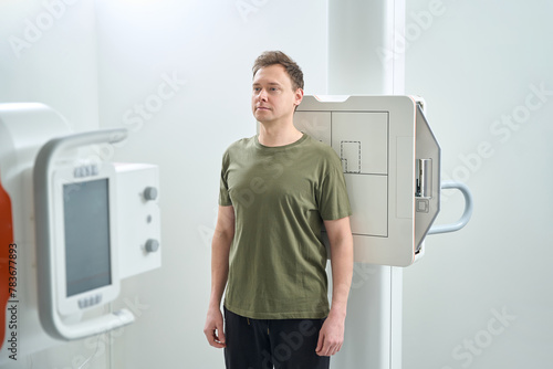 фотографія Adult man getting digital radiography of shoulder in anteroposterior projection