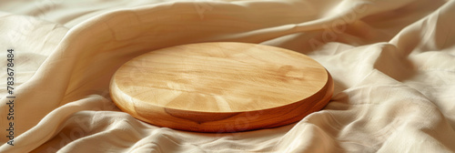Serene Wooden Platter on Soft Beige Fabric Background photo