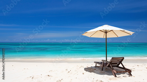 A beach chair reclined under a parasol at a beautiful tropical beach