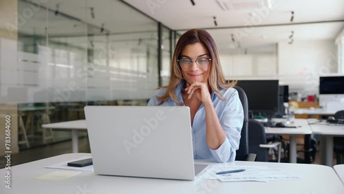 Happy busy mature business woman employee in office using laptop at work, smiling professional middle aged female company manager working looking at computer at workplace.