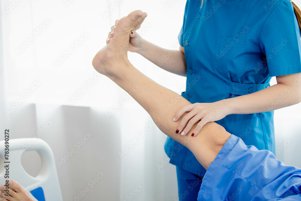 Physical therapy patient With a nurse coming to help do it.