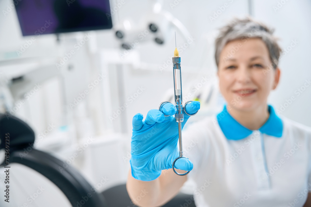 Close-up view to glass syringe with transparent liquid Close-up view to glass syringe with transparent liquid