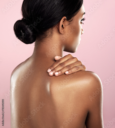 Girl, studio and back with glow, skincare and cosmetics with satisfaction and confidence. Model, aesthetic or body care for natural, clean skin and detox for self love isolated on pink background