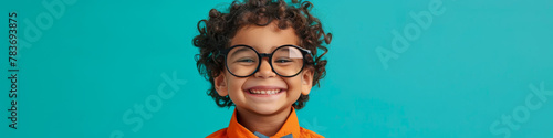 Happy Curly-Haired Child Wearing Glasses on Blue Background