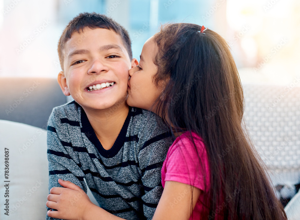 Portrait, children and happy with kiss on cheek, smile and joy in family home as kids in youth. Siblings, cute and cuddle as brother and sister on couch for affection, love and childhood development Portrait, children and happy with kiss on cheek, smile and joy in family home as kids in youth. Siblings, cute and cuddle as brother and sister on couch for affection, love and childhood development
