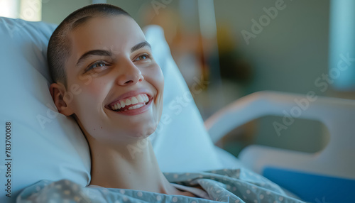 A woman with short hair is smiling in a hospital bed