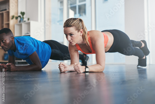 Fitness, athletes and plank exercise in gym, diversity and people in wellness centre for training and strong abdominal muscles. Coaching, health and support for core workout, active for body vitality