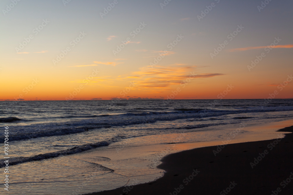 Tranquil sunset over the sea at Ostia, creating a serene and picturesque coastal landscape