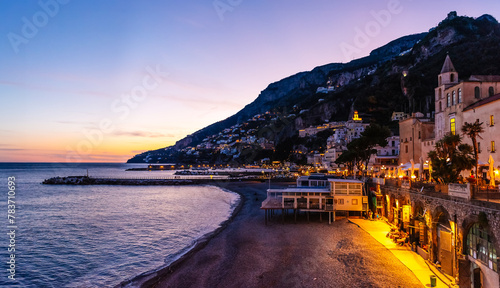 View of the mountains, coast and beaches of Amalfi in the evening at sunset photo