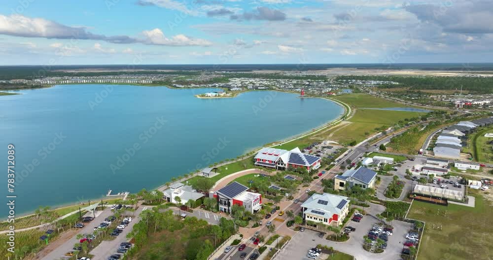 Florida office buildings with solar roof in small autonomous town. Blue photovoltaic panels for producing clean ecological electric energy. Investing in renewable electricity concept. Florida office buildings with solar roof in small autonomous town. Blue photovoltaic panels for producing clean ecological electric energy. Investing in renewable electricity concept.