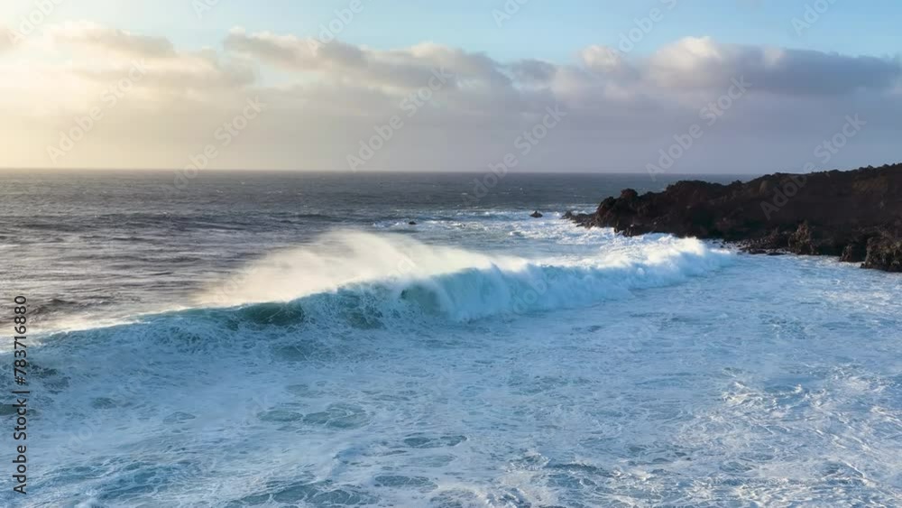 aerial slow motion view of ocean and giant waves crashing at rocky cliff with splashing and white foam. Lanzarote. Canary islands, Spain aerial slow motion view of ocean and giant waves crashing at rocky cliff with splashing and white foam. Lanzarote. Canary islands, Spain