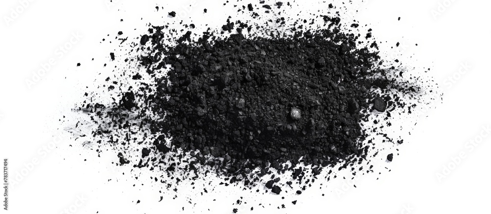 Fine black charcoal granules arranged on a clean white surface, commonly used in activated charcoal face masks