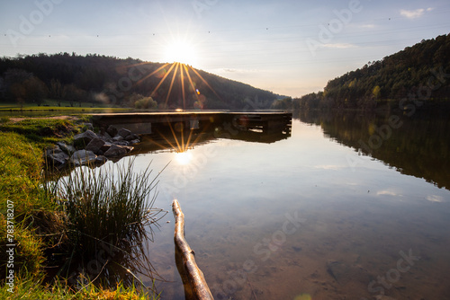 Lake in sunset. Beautiful landscape. Located in the middle of the forest and surrounded by nature, the reservoir offers a great atmosphere. Marbachstausee, Odenwald, Hesse, Germany photo