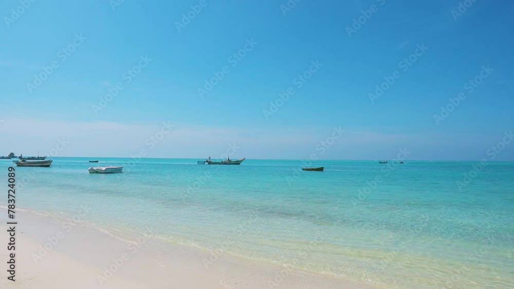 Scenic view of Lakshadweep beach with boats in ocean. Tropical Island summer landscape. View of fishing boats from beach. Tropical sandy beach and blue ocean with boats. Scenic view of Lakshadweep beach with boats in ocean. Tropical Island summer landscape. View of fishing boats from beach. Tropical sandy beach and blue ocean with boats.