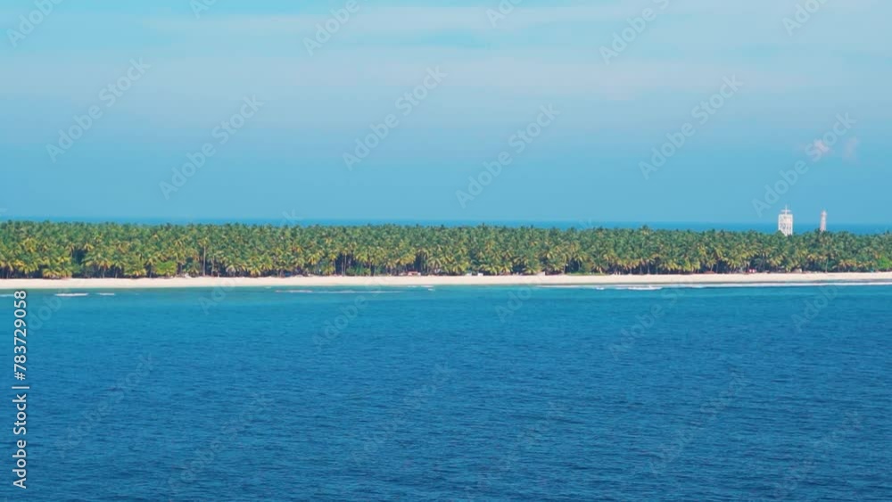 View of Agatti island from ship. Beautiful island of Lakshadweep, India. Tropical island with a white sandy beach. Summer vacation travel destination. Tropical island, lagoon. Natural summer landscape View of Agatti island from ship. Beautiful island of Lakshadweep, India. Tropical island with a white sandy beach. Summer vacation travel destination. Tropical island, lagoon. Natural summer landscape