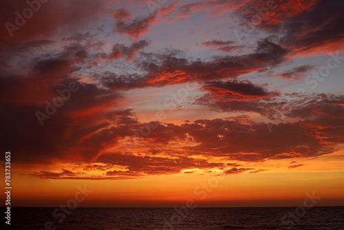 Lighting and color of the sky above the horizon at sunset. © shimon
