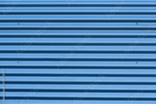 bright blue corrugated metal background with shadows