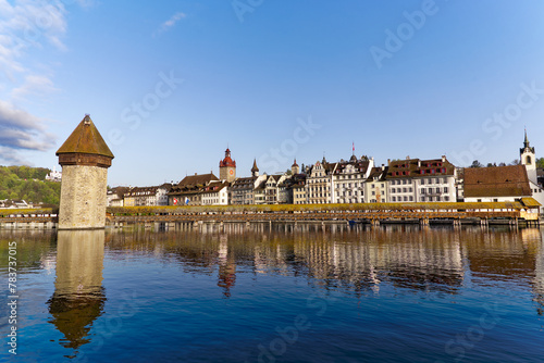 Scenic view of skyline of the old town of Swiss City of Lucerne with famous Chapel Bridge and water tower on a sunny spring morning. Photo taken April 11th, 2024, Lucerne, Switzerland.