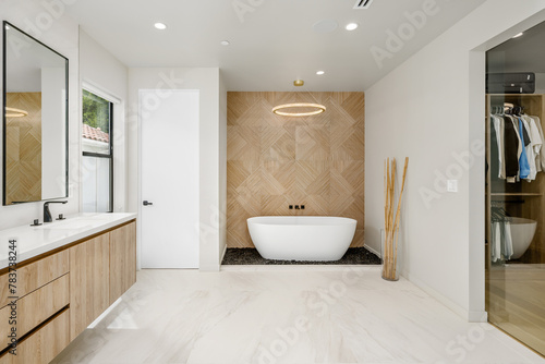 an empty bathtub sits in the middle of a bathroom with wood cabinetry
