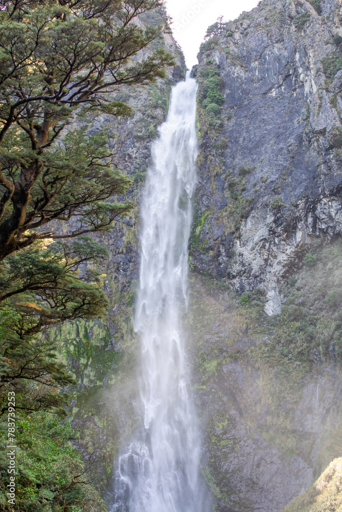 Fototapeta premium Devils Punchbowl waterfall cascades amid lush NZ greenery, a jewel of Arthur's Pass