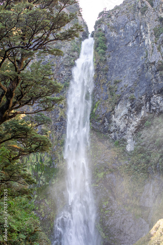 Devils Punchbowl waterfall cascades amid lush NZ greenery  a jewel of Arthur s Pass