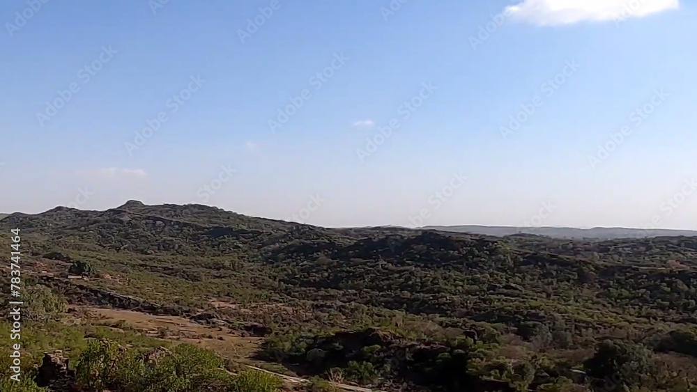 landscape with mountains and sky Rock Soil and stone Mountains Natural plants Trees Difficult roads Roads Hills Peaks Historic sites Old forts Walls Blue sky Herbs Fog Cold