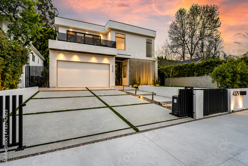 a garage and a driveway outside the house at dusk in los angeles, california © Wirestock