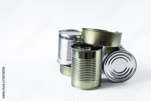 Impersonal cans with various products in close-up on a white background. Long-term storage products.
