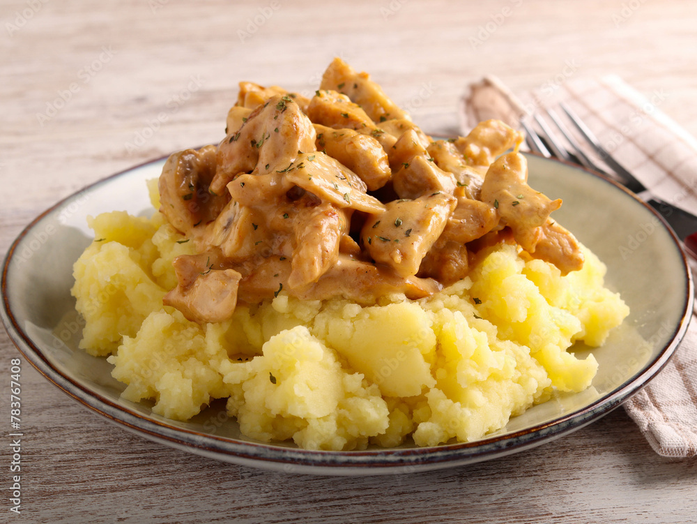 Turkey fillet with mushrooms in creamy sauce over mashed potatoes Turkey fillet with mushrooms in creamy sauce over mashed potatoes