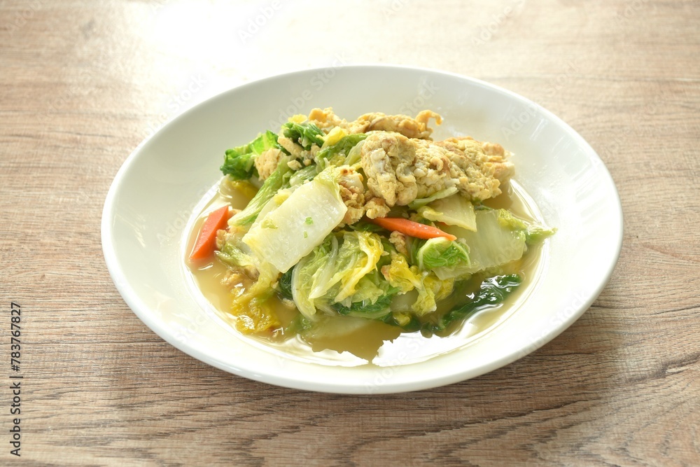 fried white Chinese cabbage with egg in soy sauce on plate fried white Chinese cabbage with egg in soy sauce on plate