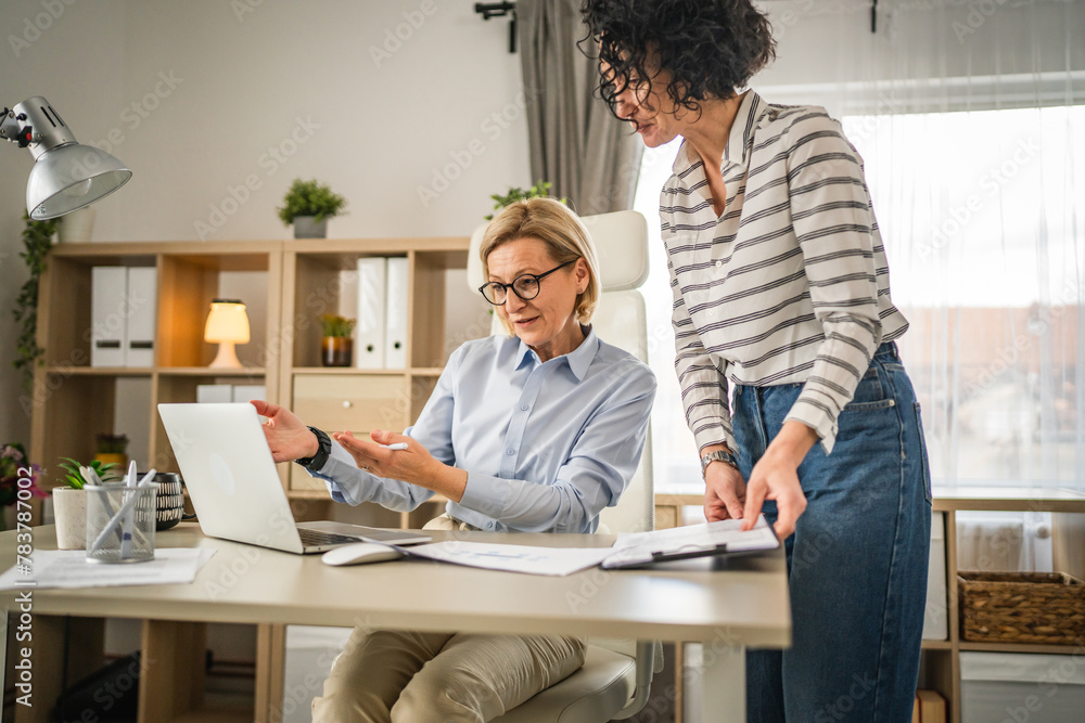 Two mature woman work and consult at office Two mature woman work and consult at office