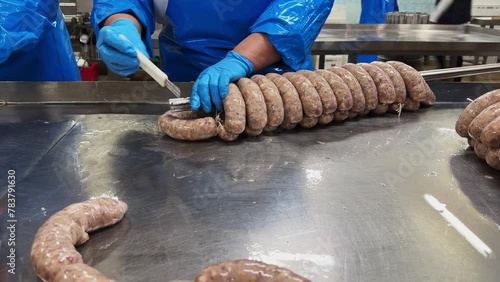 Close up of sausages production process at the meat factory. Food industry concept