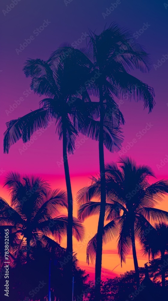 Vibrant silhouette of palm trees against a colorful tropical sunset sky