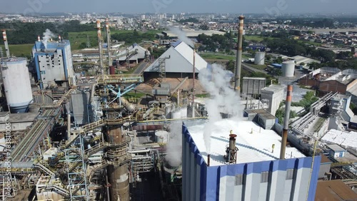 Visão aérea das fumaças que saem da chaminé em uma produção de papel e celulose, suzano, sp, brasil photo