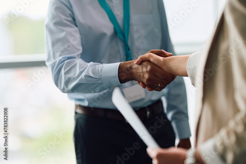 Close up of business colleagues handshaking in office.