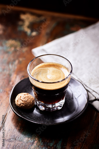 Coffee in glass cup on dark wooden background. Close up. 