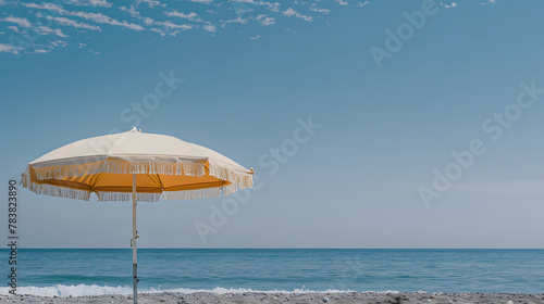 Minimal summer holidays vacation concept. Beach umbrella in front of blue sky and sea. Chilling  lounging on the beach