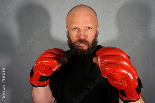 Boxer in red boxing gloves. Athlete, bodybuilder, athlete, muscle, sport, mma, fight, danger.                            Pugilist, mauler, pug, sparrer, prize-fighter