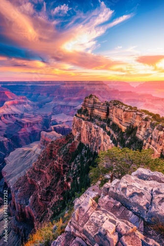 Vivid sunset over the Grand Canyon with striated rock formations and a dramatic sky