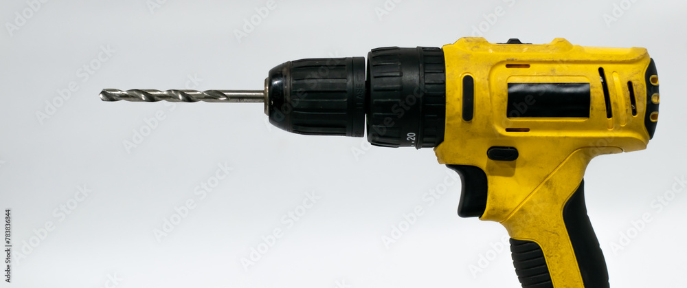 Old screwdriver with drill bit on white background. Old screwdriver with drill bit on white background.