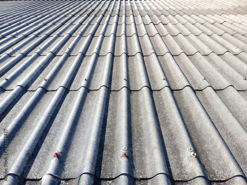 A roof with a lot of tiles and a few missing