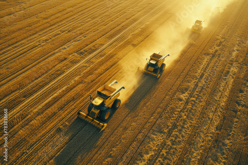 Harvesting Machines Working in Dusty Field at Sunset