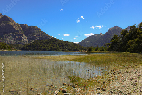 landscape of lake, mountains and forest on a sunny day © Lucía Acevedo