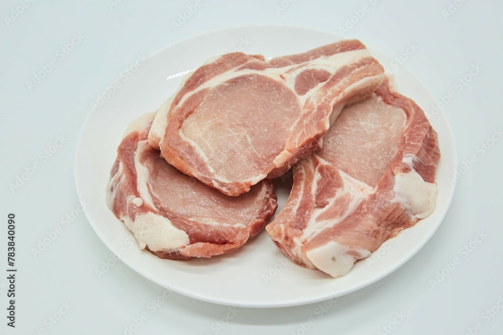 Raw meat on a white background. Pork, beef or lamb. Steak or tenderloin. Different parts of meat products for different dishes. Raw meat on a white background. Pork, beef or lamb. Steak or tenderloin. Different parts of meat products for different dishes.