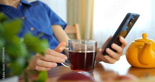 Online shopping spree on smartphone during break. Contemporary woman engaged in shopping, illustrates e-commerce trend, smart buying. Online shopping on smartphone during cozy home break.