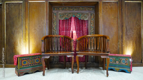 vintage heritage interior of Javanese Indonesian culture. decoration wooden chair in front of the door photo