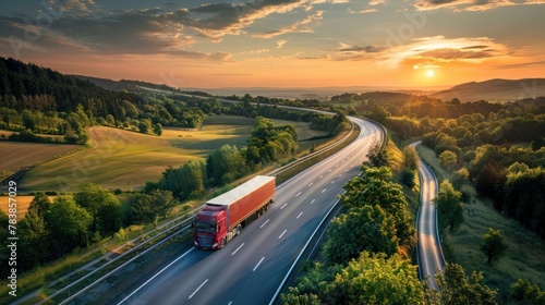 Two trucks overtake each other on a serene rural road under a stunning sunset sky photo