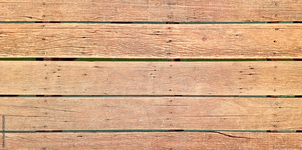 Obraz premium old wooden deck flooring background showing wood grain, nails .timber wood brown oak panels used as background with blank space for design. outdoor wooden floor.